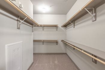 a spacious walk in closet with shelves and hangers